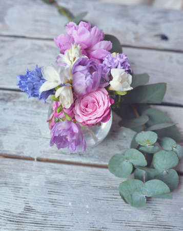 on a wooden board floral arrangement of delicate budsの写真素材