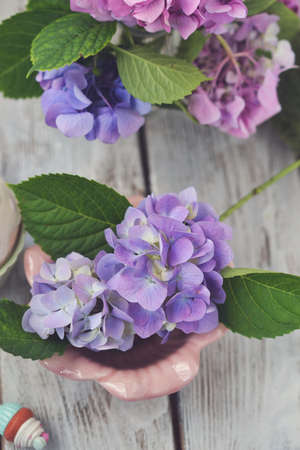on a wooden board floral arrangement of delicate buds