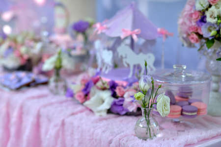 holiday table with delicate decorations, bouquets of flowers and dessertの写真素材