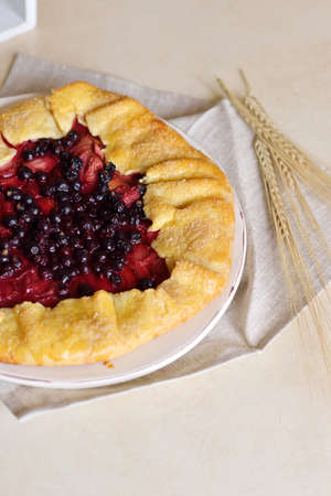 on a napkin pie ruddy juicy berries and wheat spikeletsの写真素材