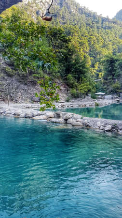 clear mountain river flowing in the forest on rocky terrainの写真素材