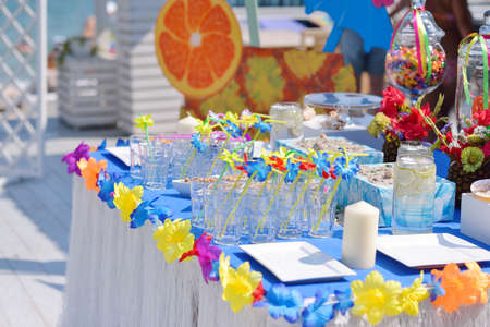 banquet table with a blue tablecloth and napkins with decorationsの写真素材