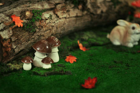 the fabulous scenery on the bright green grass mushrooms, under a tree, rabbits and hedgehogsの写真素材