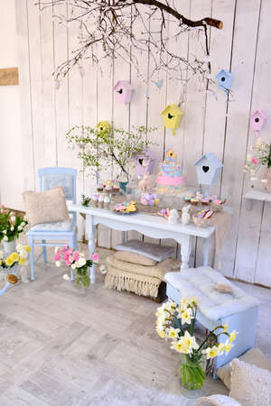 Easter decorations in the room in pastel colors, flowers, eggs, rabbitsの写真素材