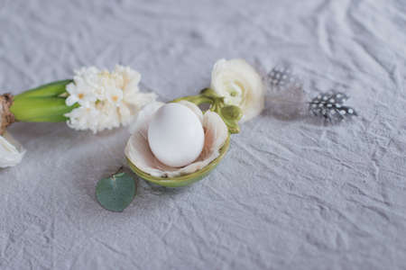 Easter still-life white egg on the petals and hyacinthの写真素材
