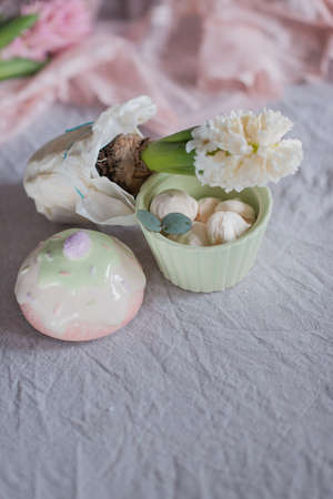 meringue cake on the table in a vase and flowers