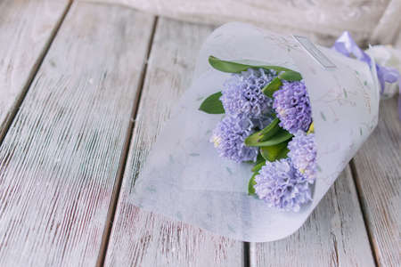 Background with fresh pink, violet and blue  hyacinths on    wooden planks. Selective focus. Place for text. Square image.の写真素材