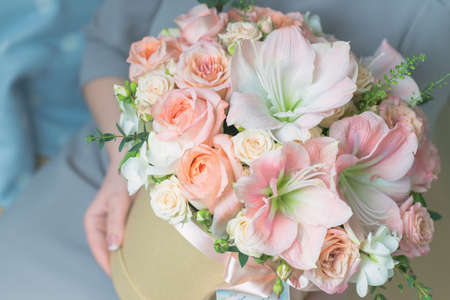 Festive composition - gift box with a bouquet of delicate flowersの写真素材