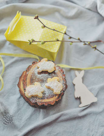 Paper gift bag with branches and cookies in the shape of a rabbitの写真素材
