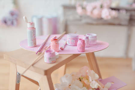 on the table jars and tubes of paint and brushesの写真素材