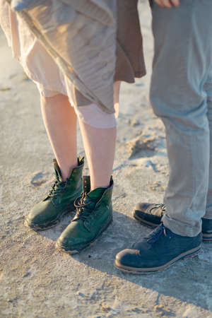 spring day on the nature of male and female legs in boots with lacesの写真素材