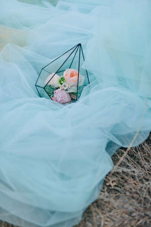 on on the blue fabric in a glass box bouquet of pink rosesの写真素材