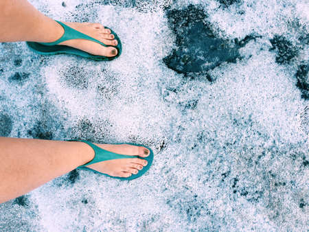 on the banks of the estuary in the salty salt sand and female feetの写真素材