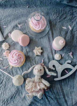 mint on a blue fabric nice festive dessert cake and wooden horse and a white bunny