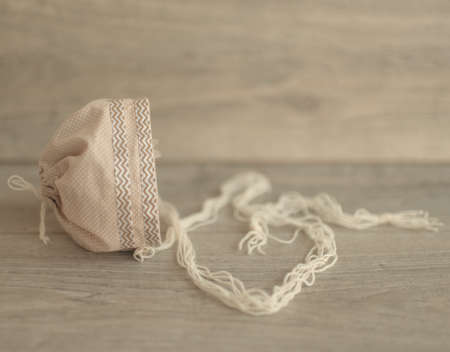 On a wooden background is a beautiful vintage children`s capの写真素材