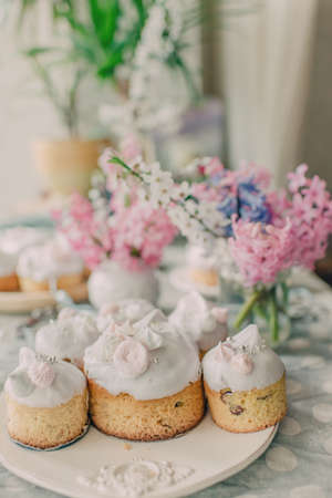 On a beautiful dish decorated with pink frosting Easter cakes and hyacinths