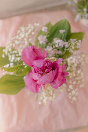 Very tender, spring bouquet of lilies of the valley and forget-me-nots and peoniesの写真素材