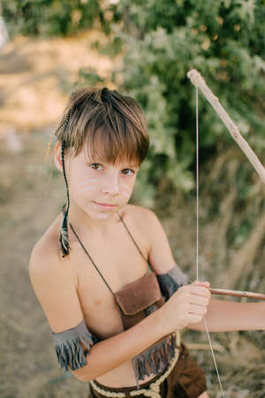 Boy playing in the indian on the seashore