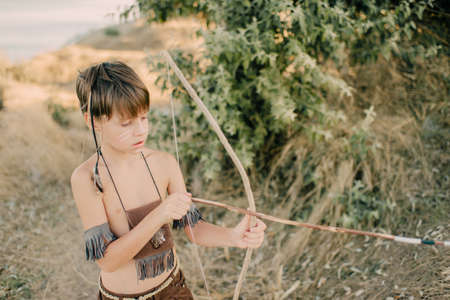 Boy playing in the indian on the seashoreの写真素材