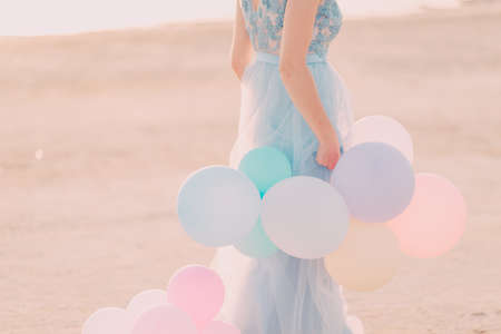 colorful balloons in the hands of a girlの写真素材