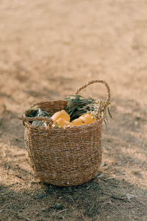 Basket with lemons on the groundの写真素材