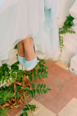 the bride's legs in blue shoesの写真素材