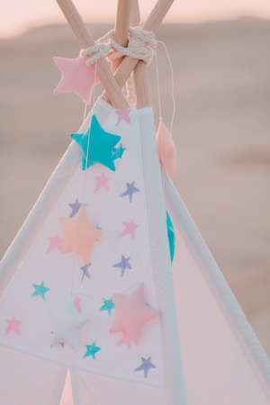 pink vintage wigwam with colorful starsの写真素材