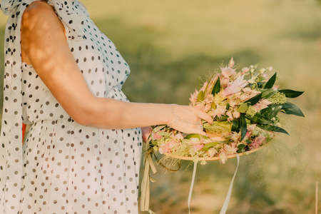 the pregnant girl on the river bank on a sunsetの写真素材