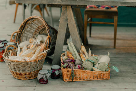 Wicker basket full of corn in the yard in loft styleの写真素材