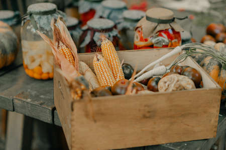 Wicker basket full of corn in the yard in loft styleの写真素材