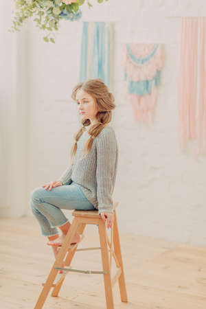 Redhead curly girl playing on the bedの写真素材