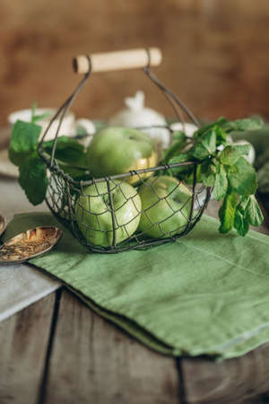 green apples in a basket in a rustic style