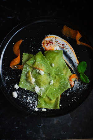 ravioli with spinach and pumpkin with creamy sauce and cheeseの写真素材