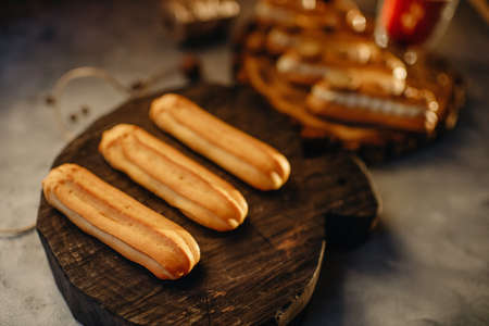 Homemade cakes, dessert eclair with cream and edible decor