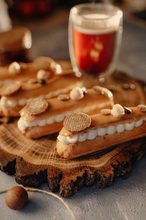 Homemade cakes, dessert eclair with cream and edible decorの写真素材