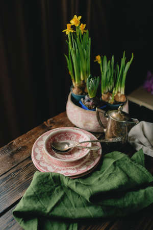 Spring table decoration with crockery and flowersの写真素材