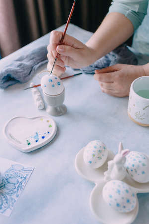 coloring eggs for the spring holiday of easter in blue tonesの写真素材