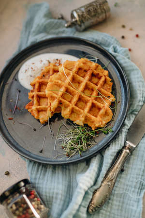 baked Belgian waffles on a plate with creamy sauce and spicesの写真素材