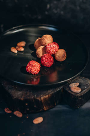 handmade chocolate truffle candies on black backgroundの写真素材