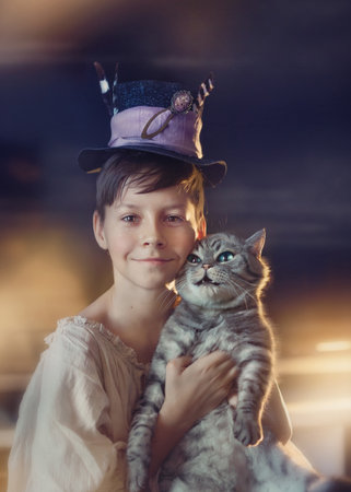 boy in a hat with a cat on a holiday halloween