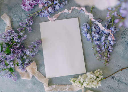 mockup of a sheet of paper for a signature or a card for a holiday with a bouquet of flowersの写真素材