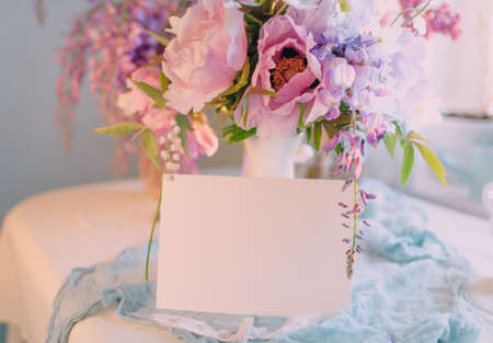 mockup of a sheet of paper for a signature or a card for a holiday with a bouquet of flowersの写真素材