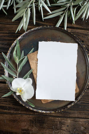 white blank sheet of paper on a plate, menu mockup, invitation mockup, business card or letter mockupの写真素材