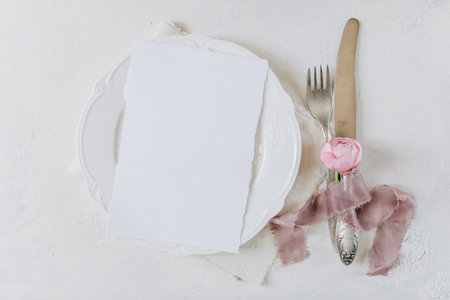 white blank sheet of paper on a plate, menu mockup, invitation mockup, business card or letter mockupの写真素材