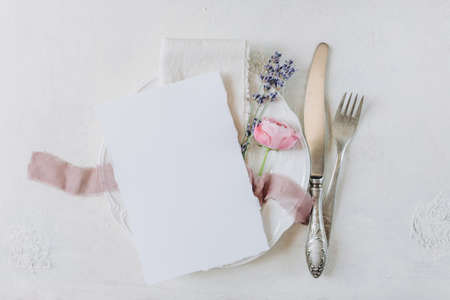 white blank sheet of paper on a plate, menu mockup, invitation mockup, business card or letter mockupの写真素材