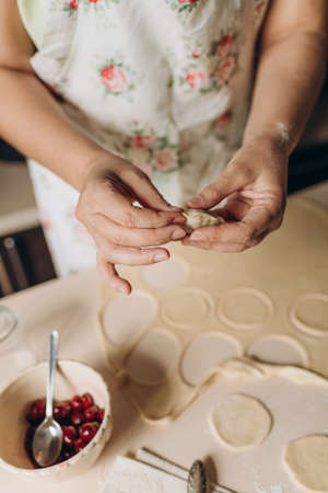 the process of making dough in the kitchen at home, home cooking, female hands prepare foodの写真素材