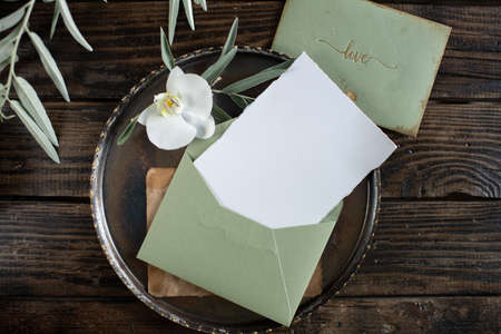white blank sheet of paper on a plate, menu mockup, invitation mockup, business card or letter mockupの写真素材