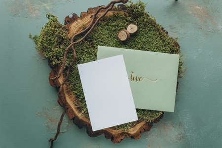 Moss and card mockup on rustic wooden background, top viewの写真素材