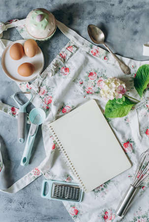 recipe book mockup on kitchen table with kitchen utensils in vintage styleの写真素材