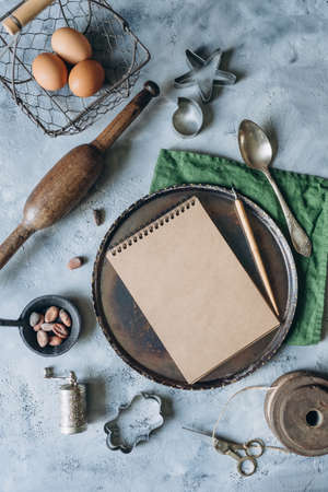recipe book mockup on kitchen table with kitchen utensils in vintage styleの写真素材